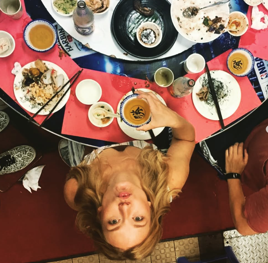 Carla at a table shared with friends